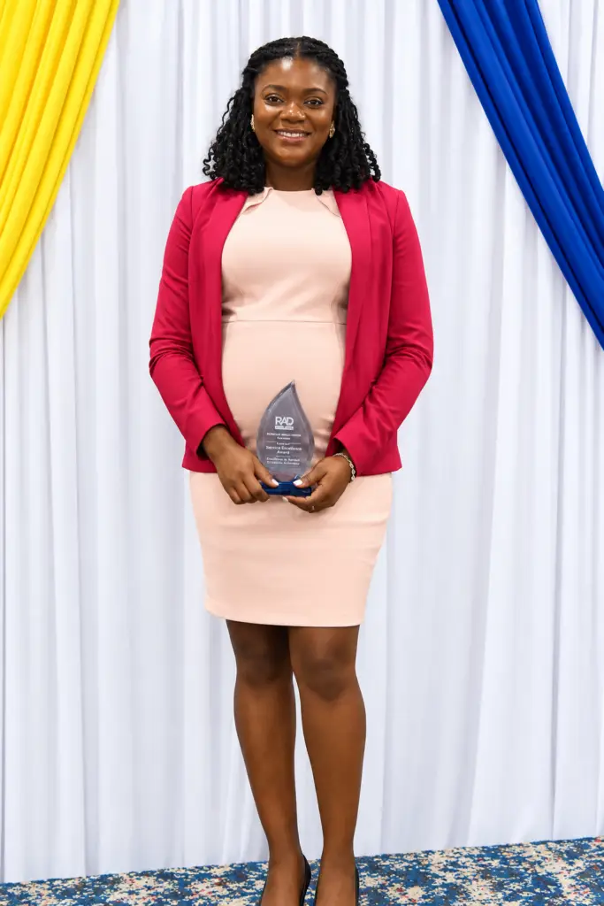 Mrs. Keniesha Fletcher with the Most Improved Staff award.
